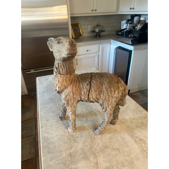 A beautifully weathered antique European folk art sheep, hand carved from solid wood with deep, expressive tool marks...
