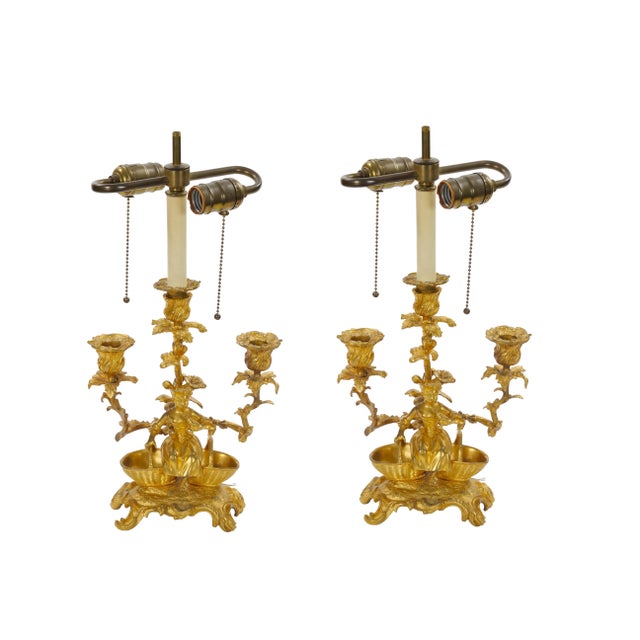 An elegant pair of antique French gilt bronze table lamps, crafted during the mid to late 19th century in the refined...