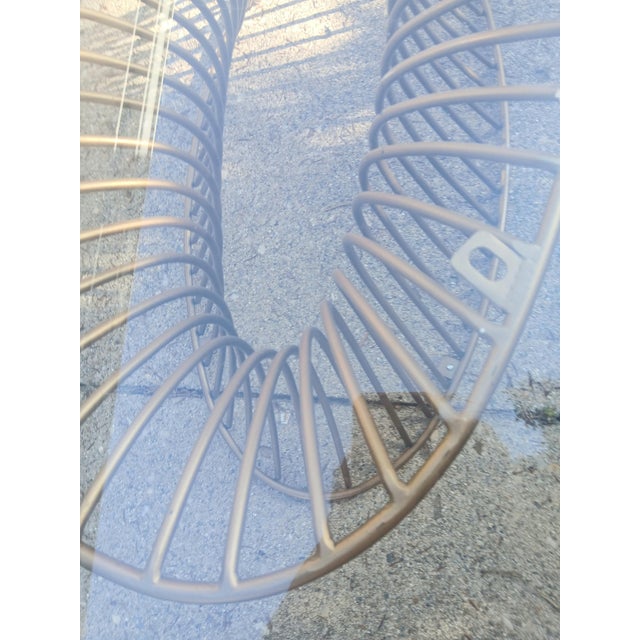 Vintage 1970's welded metal coffee table with glass top. Oval shaped, and finished in gold gilt. A showstopper! In...