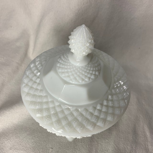 This is a vintage Westmoreland white milk glass English Hobnail pedestal candy dish with a matching lid featuring a...