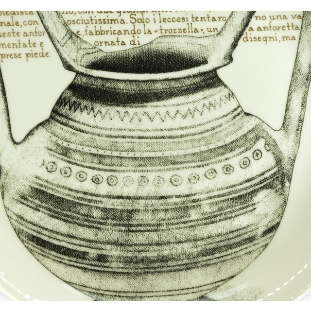 Trozzella Leccese - for Martini & Rossi is a silk-screened porcelain plate, designed by Piero Fornasetti for Martini &...