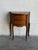 This compact rosewood and teak entry table features a curved front, two drawers, and a shaped top. Slender cabriole legs...