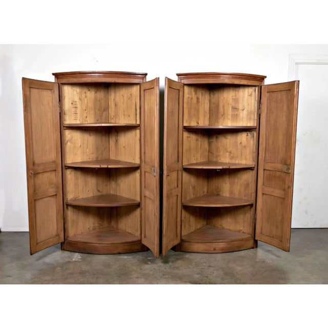 A wonderful pine corner cabinet crafted from antique French boiseries panels. Ample shelving to the interior. Dimensions:...