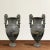 A phenomenal pair of early 20th century French cast bronze Roman-style urns with volute handles decorated with goose...