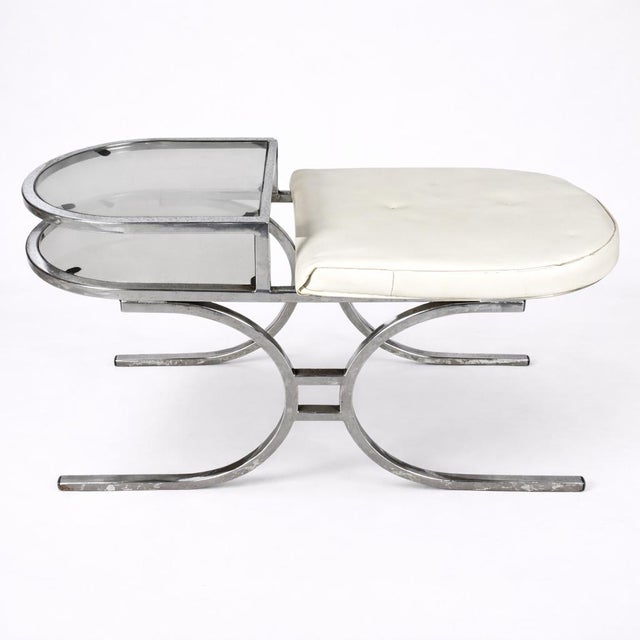 A striking mid-century chrome and smoked glass telephone bench, designed in the bold space age style of the 1970s....