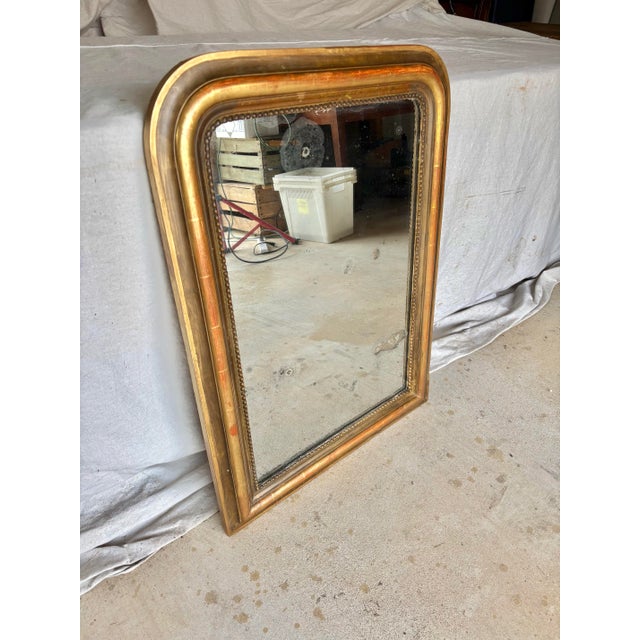 Found in Provence, this 19th Century French Louis Philippe Giltwood Wall Mirror was crafted in the late 1800's. The piece...