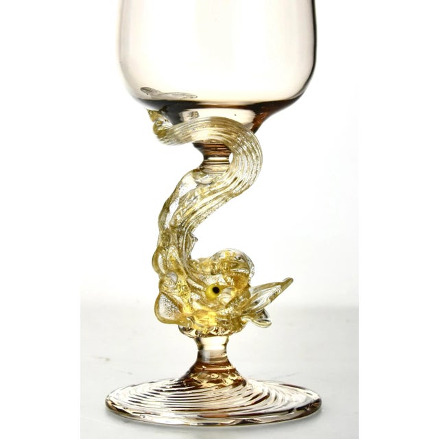 Seven magnificent hand blown Venetian goblets having 24 karat gold embedded in the swirling sculptural dolphin stems, the...