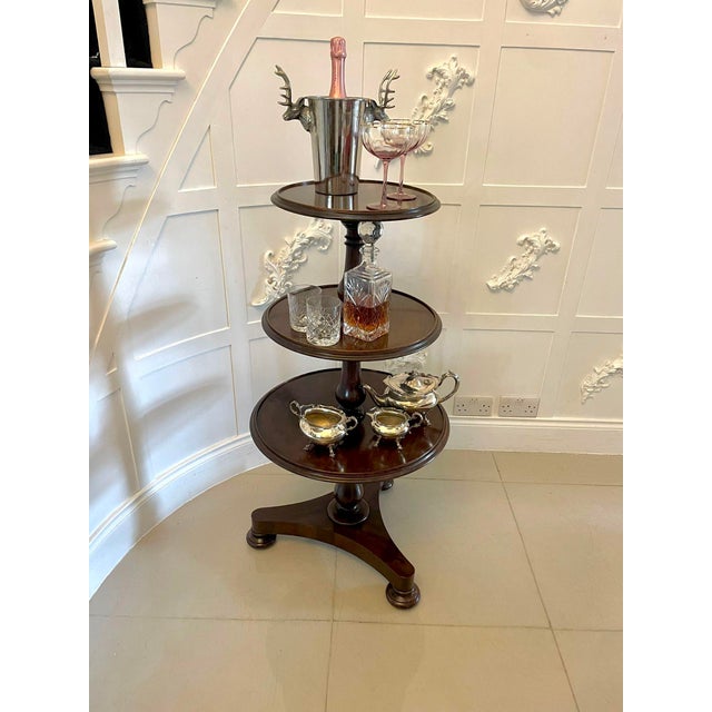 Antique George III quality mahogany circular dumbwaiter having three circular shelves with a moulded edge supported by...