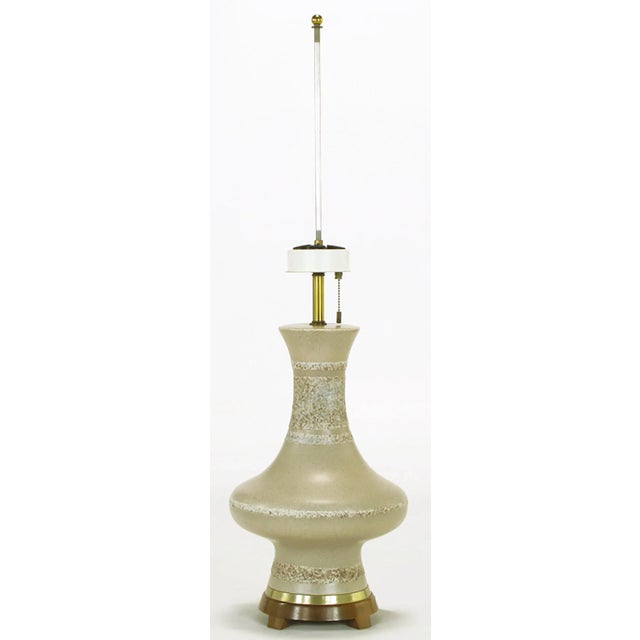 Modernist urn form table lamp with a heathered glaze pottery body, footed wood base and brass spacer. Brass stem with a...