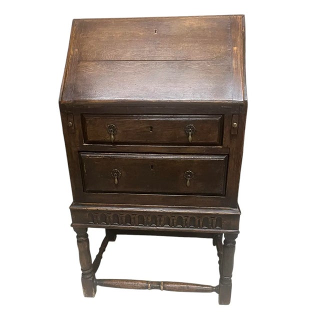 The Front of the desk drops down to reveal interior desk space. In excellent condition considering age and use.