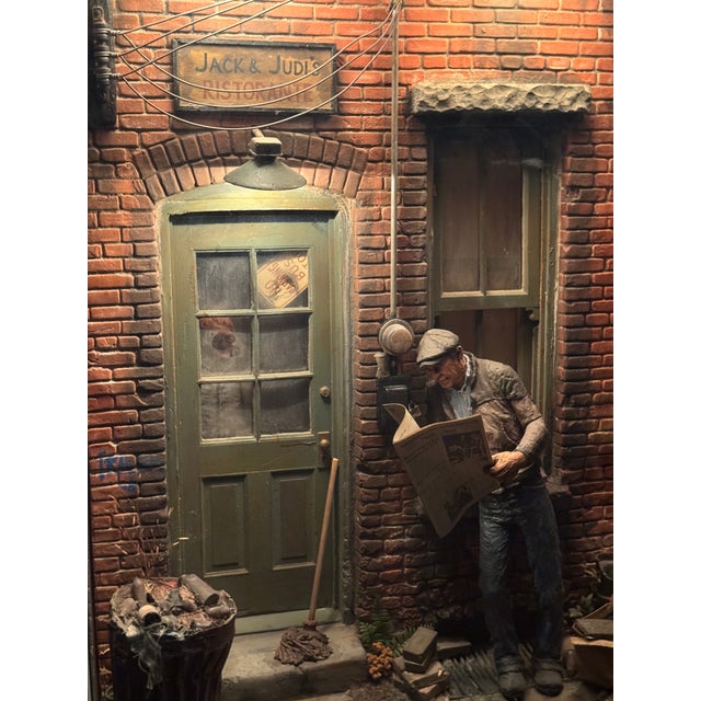 Original illuminated cityscape sculpture by Michael Garman, titled “Door Window – Jack and Judi’s Ristorante.” This piece...