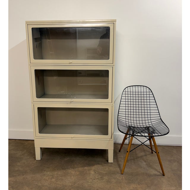 A handsome set of three vintage industrial barrister bookcases or display cabinets constructed of steel with large glass-...