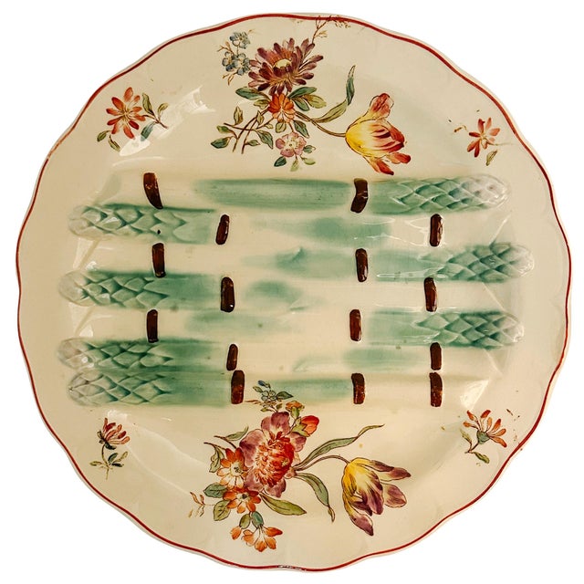 A late 19th century French antique asparagus plate by Longchamp featuring four sculptural, hand-painted asparagus spears...