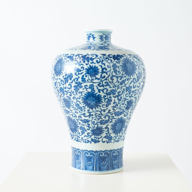 Blue & White Meiping Vase with Interlocking Lotus A decorative blue and white meiping, or plum vase, with interlocking...