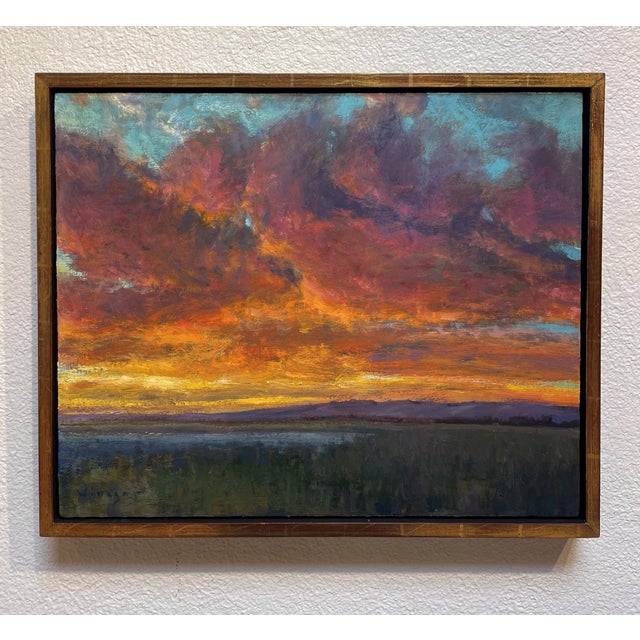 Prism Sky captures a breathtaking sunset where vibrant hues of orange, purple, and blue intermingle in the sky, reflecting...