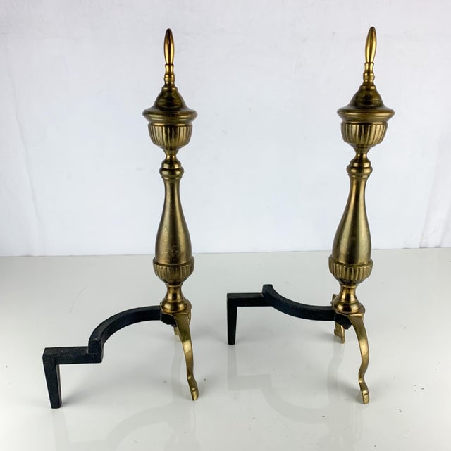 Lovely set of vintage brass and cast metal andirons. Classic style and shape. Great addition to your vintage home decor...