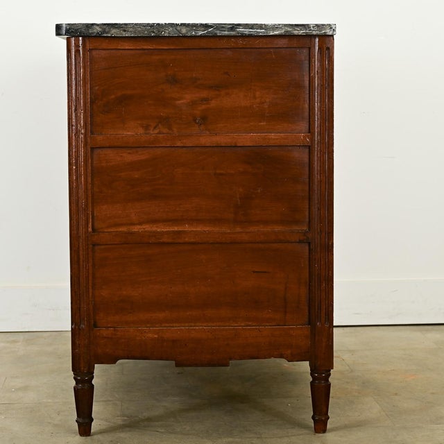 Dimensions: 35” H x 44 ¾” W x 23 ⅞” D An elegant walnut & marble commode from France, 19th century, with finely carved...