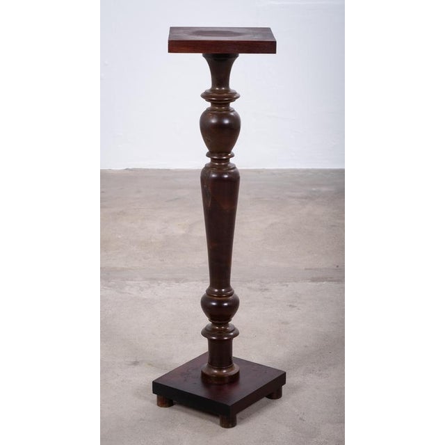 Elegant Danish pedestal stand from the 1940s, crafted in walnut. Ideal for displaying a vase, sculpture, or other...