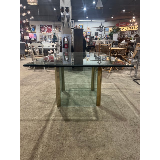 Channel timeless glamour with this Hollywood Regency style clear glass dining table. The sleek, transparent glass top...
