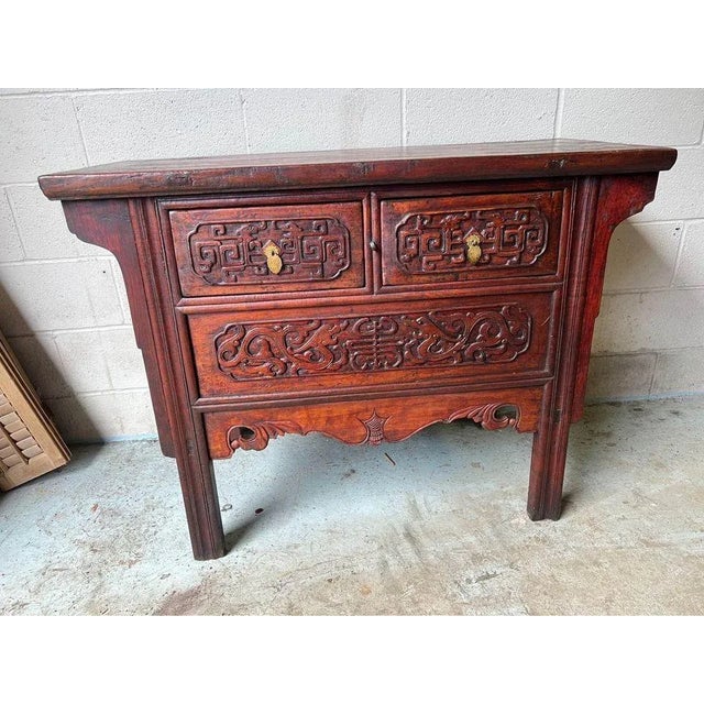19th Century Chinese Carved Red Painted Consoler Table. This console table features 2 small drawers on the top. All...