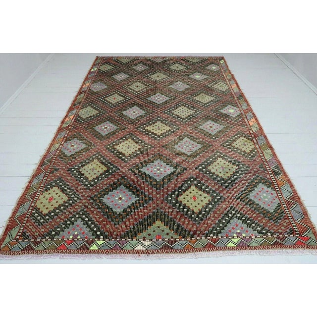 This beautiful, vintage, handwoven kilim rug is approximately 60 years old. It is handmade of hand spun wool in all...