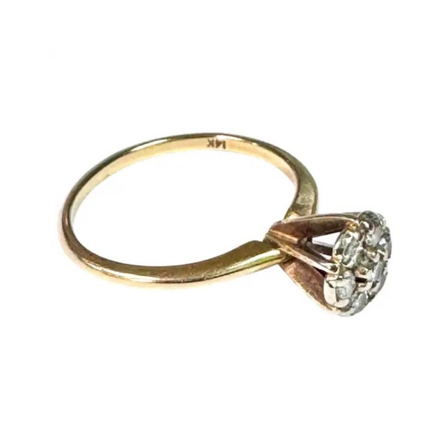 Vintage 14K Yellow Gold and Diamond Cluster Ring. Ring features a sparkling floral-inspired cluster of seven round...
