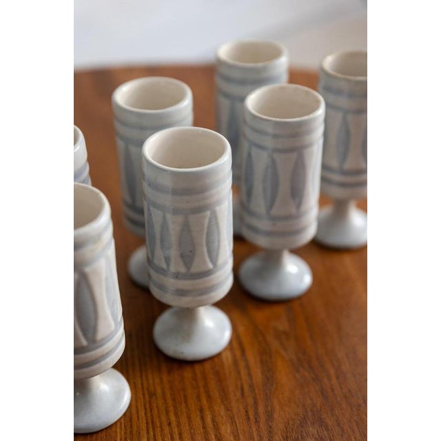 Set of 8 gray and white ceramic glasses decorated with shuttles. Signed and dated 1976. French ceramic.