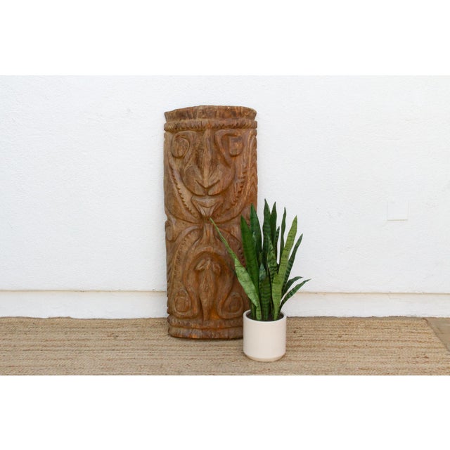 This 46-inch carved post is a Māori piece from Aotearoa, New Zealand, worked from a single dense log with a deep convex...