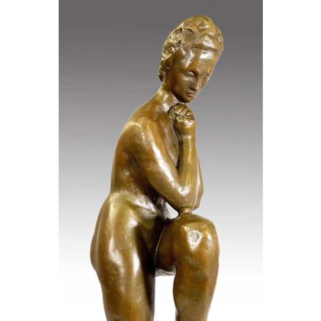 Sculpture in bronze, Girl with Leaning Leg. Bronze, the young girl rests one foot on a raised form, her chin leaning on...