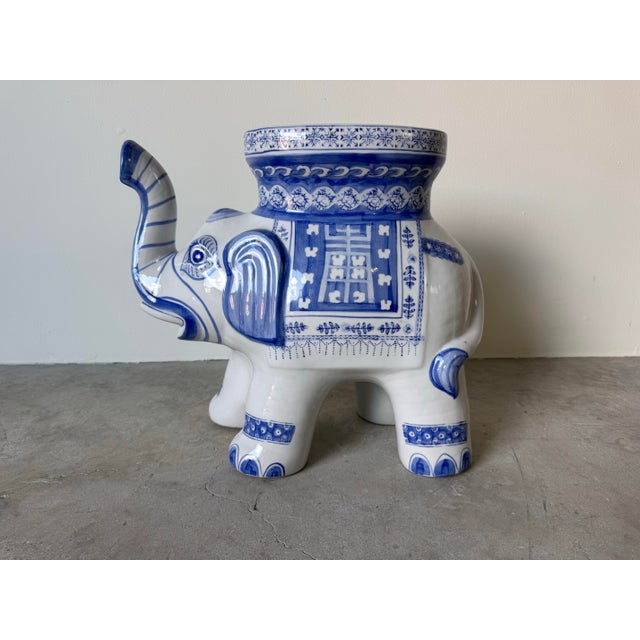 Charming vintage ceramic elephant garden stool, hand-crafted and hand-painted in a classic blue and white palette inspired...