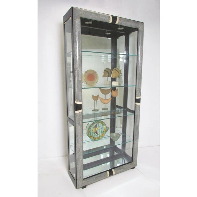 This is a stunningly beautiful pair of vintage tessellated stone Art Deco styled display cabinets. The front outer frame...