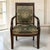 A refined 19th century French Empire period armchair, handcrafted in richly toned mahogany with the disciplined...