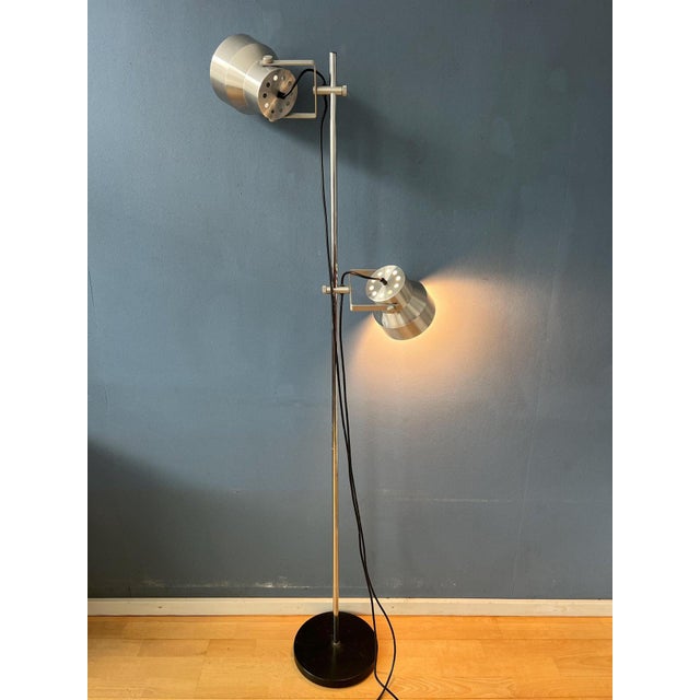 Mid century Dijkstra floor lamp with two aluminum adjustable shades. The two spots can be moved up and down the base and...