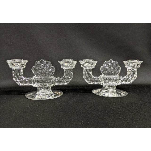 A pair of Fostoria double arm candle holders from the 1950s. The vintage art deco taper holders were manufactured from...