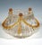 Mould-blown colourless glass with a wavy wall that widens flatly and bulbously at a flush base before curving inwards...