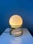 Set (2) of mid century hollywood regency eyeball table lamps with golden spiral base and opaline glass shade. The shades...