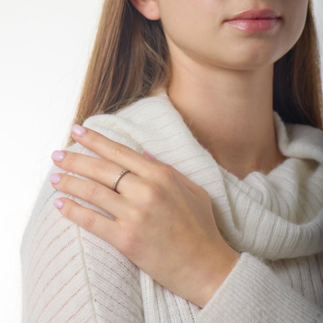 This refined Mid Century half eternity band is a timeless expression of understated elegance, showcasing classic diamond...