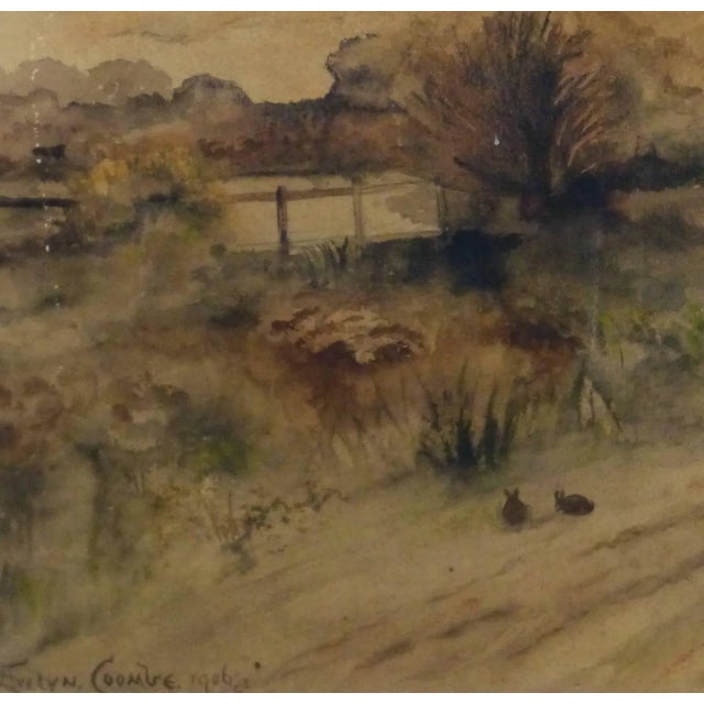 Bucolic watercolor landscape of a unpaved road rounding past hay fields, two rabbits graze nearby by artist Evelyn Coombe,...