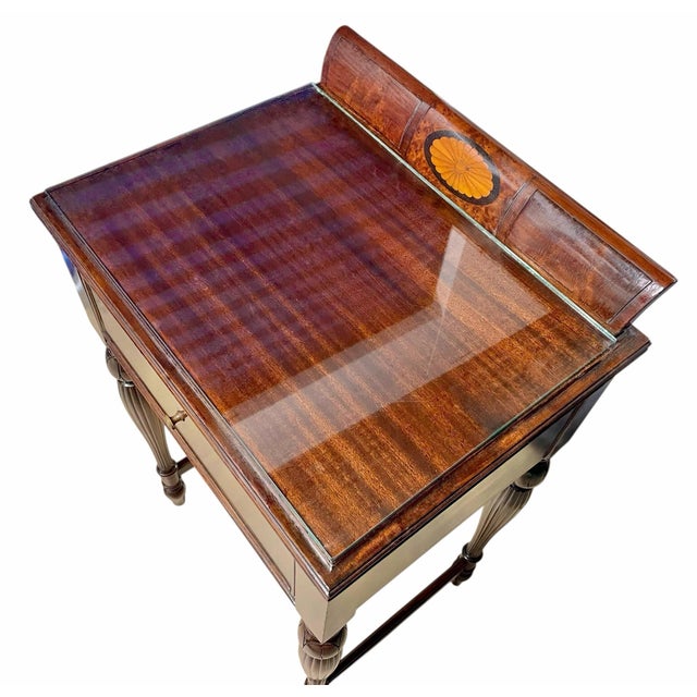 Beautiful antique mahogany writing table featuring a curved gallery back with a stunning sunburst inlay medallion. This...