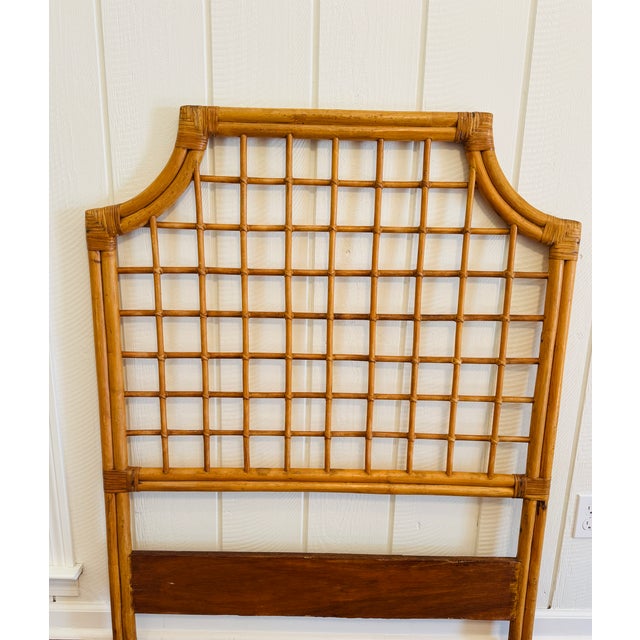 Vintage twin bamboo headboard with lattice grid design, curved pagoda shape, and a well-preserved honey patina. A timeless...