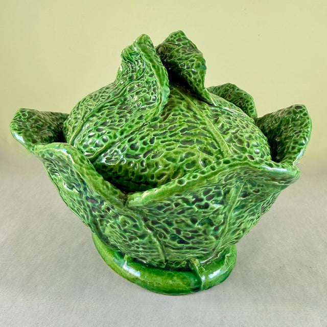 From Portugal, a hand potted majolica glazed cabbage leaf lidded oval shaped tureen, circa 1930s. Rustic, and showing the...