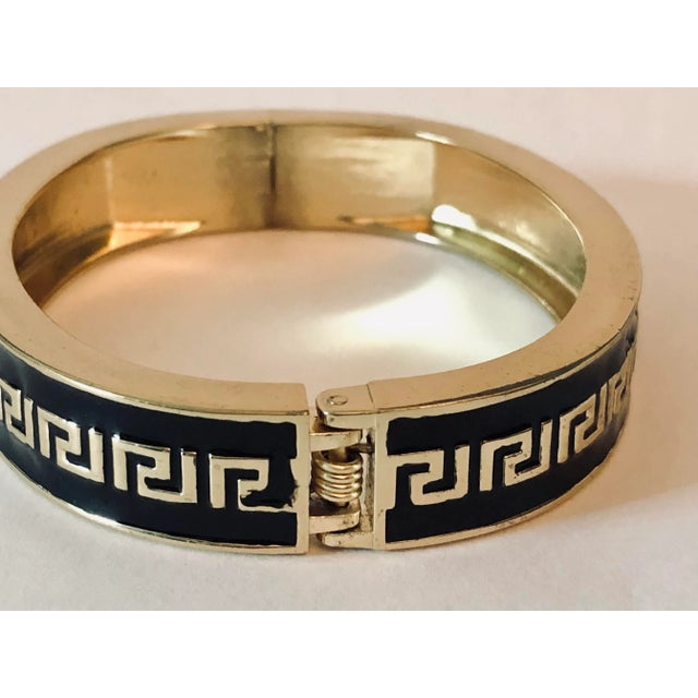 This Vintage Black Enamel Gold Greek Key Hinged Bangle is a tried and true classic! Perfect for the office, church or e...
