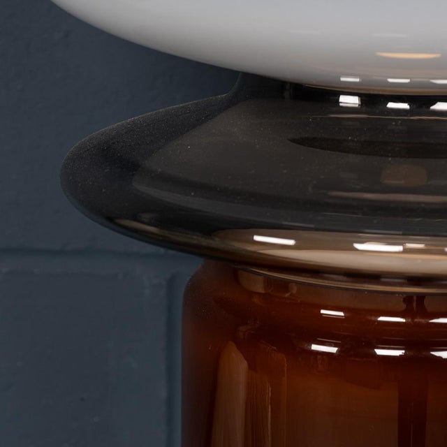 This sculptural hand-blown glass lamp, crafted in Murano, Venice, Italy, is a stunning example of contemporary design. The...