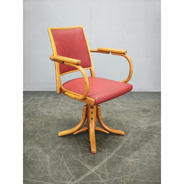 Original height-adjustable swivel office chair manufactured by Ligna in Czechoslovakia during the 1950s. Expertly crafted...