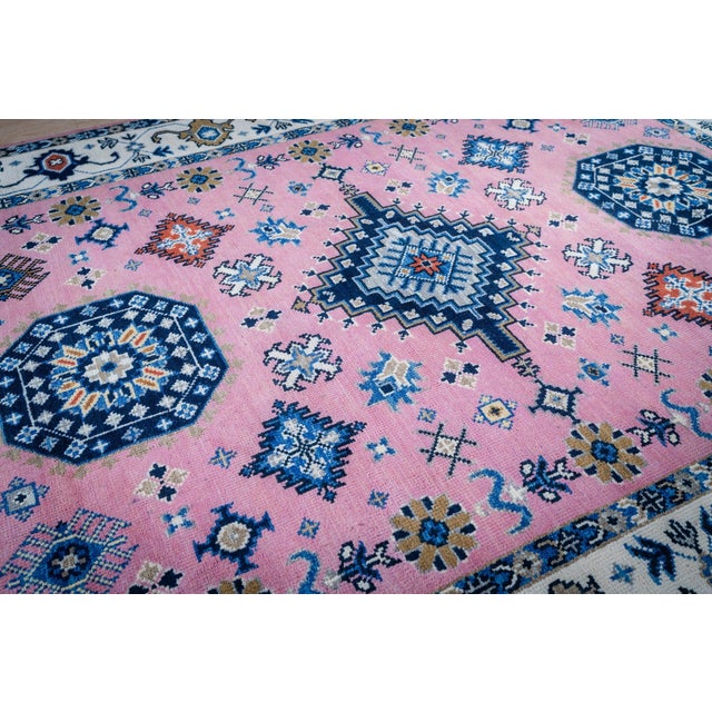 A hand-knotted wool rug from the Kazak collection, made in India and measuring 8' x 10'. Classic drawing on an ivory...