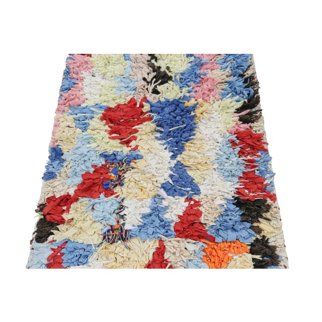 Hand-knotted in wool and originating from Morocco circa 1950-1960, this 2x5 vintage Moroccan rug is an extremely rare...