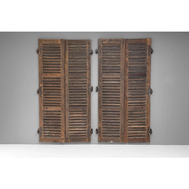 Two pairs of French pine shutters with original metal hinge parts. Circa 1850.