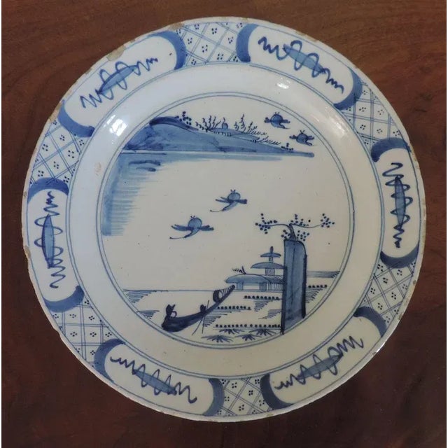 Antique 18th c. Delft charger plate decorated in blue & white glaze. Although from Holland, the decoration mimics Kangxi...