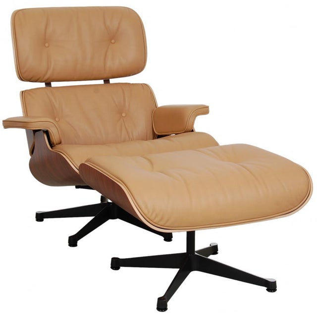 Charles Eames Lounge chair with ottoman in caramel-colored leather, and with a back of rosewood. The chair is new and has...