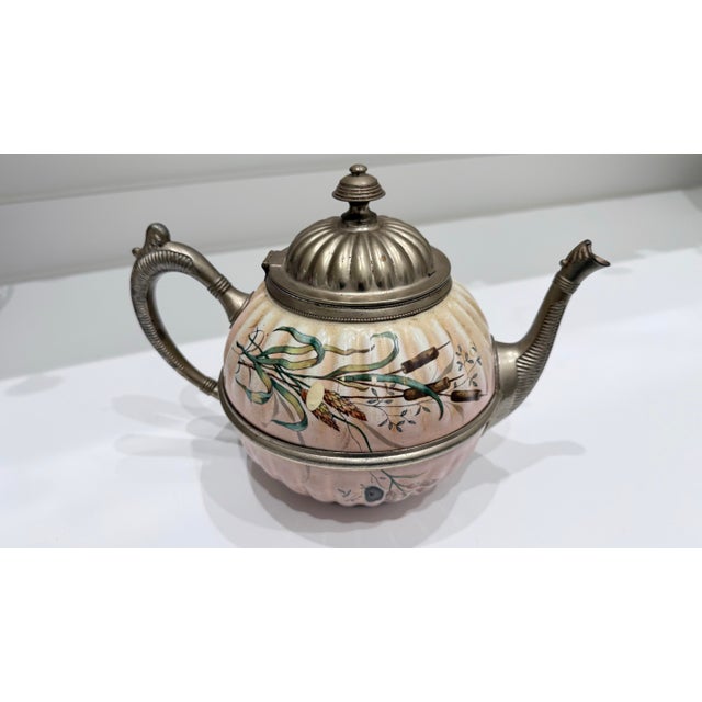 Elegant vintage decorative teapot featuring a hand-painted cattail and marsh scene on a soft blush-colored porcelain body...
